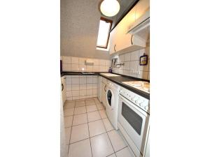 a kitchen with a washer and dryer at Ferienhaus Seeschwalbe in Dornumersiel in Dornumersiel +33 photos
