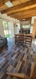 a kitchen and living room with a checkered floor at Cabañas del Sol in Punta Del Diablo