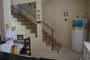 a kitchen with a staircase in a house at casa da serra in Penedo