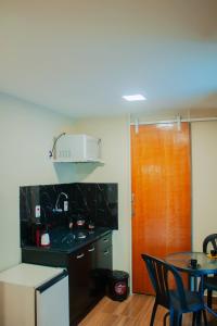 a kitchen with a counter and a table with chairs at Villa de Recriary in Campos do Jordão +11 photos