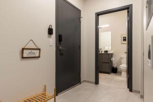 a bathroom with a black door and a toilet at Luxury Downtown - King Bed- Lake Views in Cleveland +40 photos