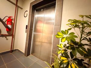 a shower stall in a bathroom with a plant at Harlem Suites in Kiambu