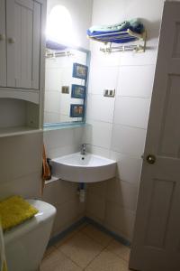 a small bathroom with a sink and a toilet at 3-room apartment steps from Los Dominicos in Santiago
