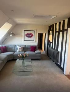 a living room with a couch and a glass table at The Grange, Northill in Northill