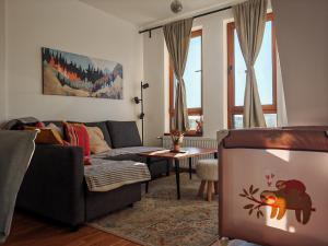 a living room with a couch and a table at Aries apartman Divčibare in Divčibare