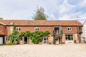 - une vue sur l'extérieur d'une grande maison en briques dans l'établissement Mulberry Coach House, à East Rudham