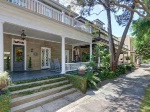 a house with a porch and stairs leading to the front door at Southern Hall Lower in Savannah
