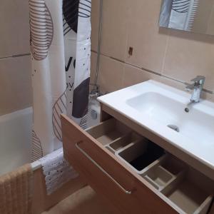 a bathroom with a sink and a shower curtain at Duplex LLORACH I in Omellóns +40 photos