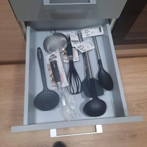 a drawer full of kitchen utensils in a cabinet at Duplex LLORACH I in Omellóns