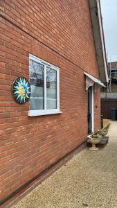 a window of a brick building with a clock on it at The cottage in Bury Saint Edmunds