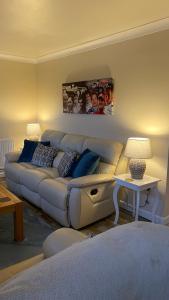 a living room with a couch and a table at The cottage in Bury Saint Edmunds