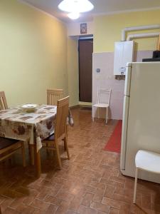 a kitchen with a table and a refrigerator at Da nonna Maria in Celano