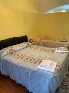 two beds in a room with towels on them at Da nonna Maria in Celano