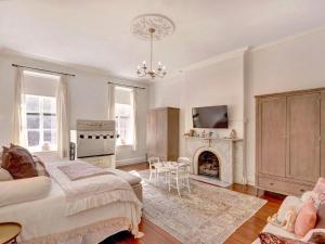 a bedroom with a bed and a fireplace at Elsewhere on Madison Square Main in Savannah