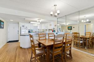 a kitchen and dining room with a table and chairs at Amelia South Beach Condo in Fernandina Beach