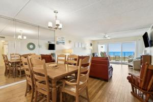 a dining room and living room with a table and chairs at Amelia South Beach Condo in Fernandina Beach