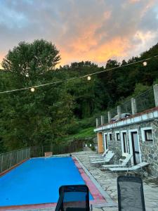a large blue swimming pool on top of a house at Casa San Bartolomeo in Riccò del Golfo di Spezia