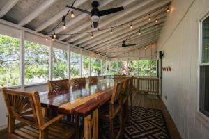 a dining room with a long table and chairs at Edisto Echo in Edisto Beach