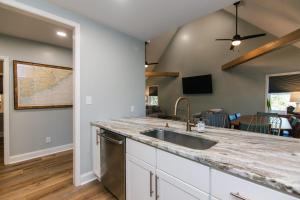 a kitchen with a sink and a counter at Edisto Echo in Edisto Beach +52 photos