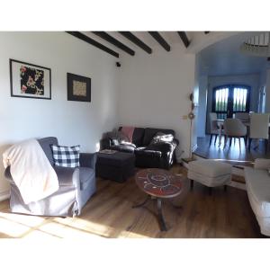 a living room with a couch and a table at Villa Gustavine - Maison d'Architecte in Ger