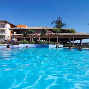 a group of people swimming in a swimming pool at Ilhas do Lago Eco Resort in Caldas Novas