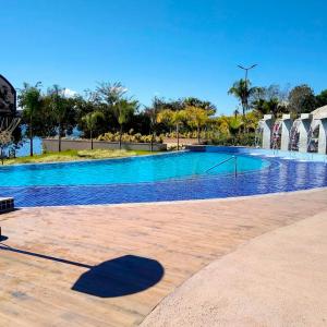 a large swimming pool with blue water at Ilhas do Lago Eco Resort in Caldas Novas