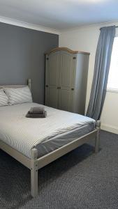 a bedroom with a bed and a cabinet and a window at Whole property in Kirkcaldy Fife in Fife