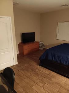 a bedroom with a bed and a television on a dresser at West Valley King Room 94th in Phoenix