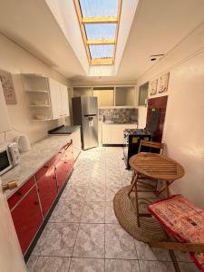 a kitchen with a skylight and a table in it at Casa Cypresses in Temuco