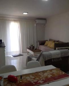 a living room with a couch and a table at Departamento en Alquiler en Carlos Paz in La Porteña +15 photos