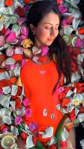 a woman standing in front of a pile of flowers at Nalanda SPA & Casa de Montaña in Patate