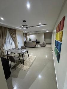 a living room with a table and a couch at Epic Apartment in Abuja +24 photos