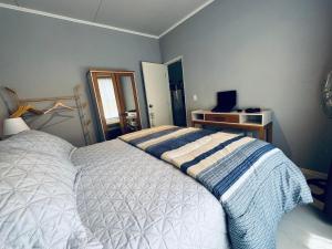 Ένα ή περισσότερα κρεβάτια σε δωμάτιο στο Tierra Luna, Casa de Huéspedes