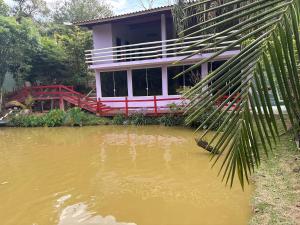 a house sitting on top of a body of water at Marcos Araújo in Mairinque