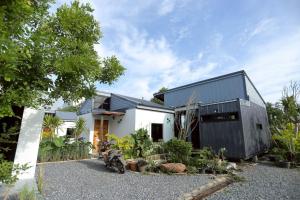 a house with a black and white facade at Wasana Village Phutoei in Ban Phu Toei