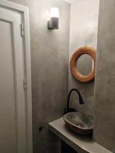 a bathroom with a sink and a mirror on the wall at Studio Dimon in Pleven +4 photos