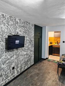 a living room with a tv on a wall at Studio Dimon in Pleven