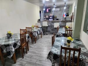 a restaurant with tables and chairs with flowers on them at Hotel Villa del Mar in Panama City