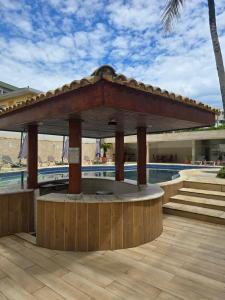 a gazebo sitting next to a swimming pool at Senses Praia Hotel - Frente Mar in Guarujá +32 photos