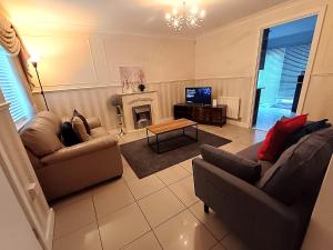 a living room with two couches and a television at Luxury 3 Bedroom House with Parking in Northfleet
