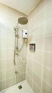 a shower with a shower head in a bathroom at Wasana Village Phutoei in Ban Phu Toei +25 photos