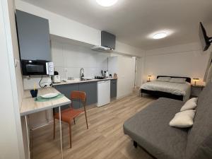 una piccola camera con letto e cucina e una camera da letto di Estudios Areal a Vigo