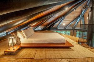a bed in a room in a attic at Daintree Cascades in Cape Tribulation