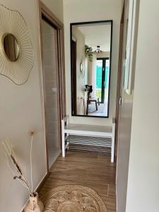 a hallway with a large mirror and a table at Cosy studio Noha in Thonon-les-Bains