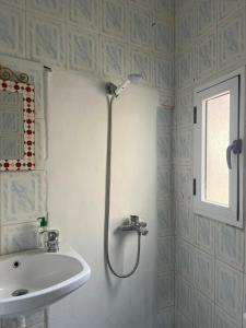a bathroom with a shower and a sink at Arch Guesthouse - Dorm for Budget Travelers in Tangier in Tangier