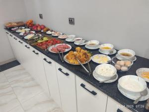 a buffet with many plates of food on a counter at Samanid hotel in Salor Bekati