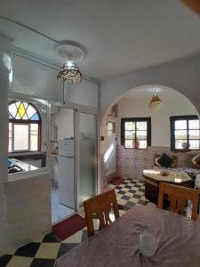 a kitchen and living room with a table and chairs at Arch Guesthouse - Dorm for Budget Travelers in Tangier in Tangier +74 photos