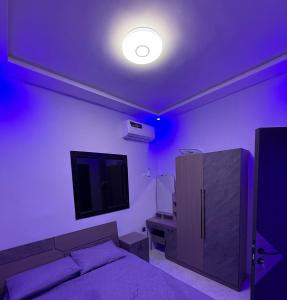 a bedroom with a bed and a tv on the wall at Modern Stay in Nouakchott