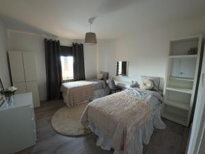 a room with two beds and a living room at Whole 3-room apartment, 10 min from malmo C & 2 min from shops in Malmö