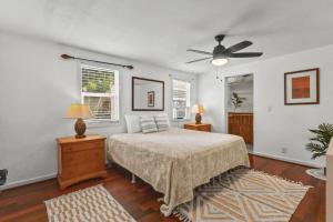 a bedroom with a bed and a ceiling fan at Hale Kulamanu in Hauula